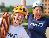 PHEAA employees smiling with helmets and climbing rope